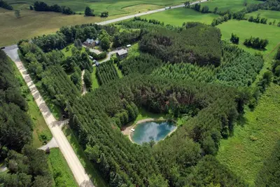 an aerial view of a lake in a forest at A rustic cabin in the woods in Orangeville