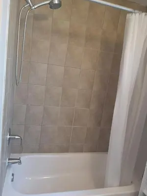 a shower in a bathroom with a shower curtain at Comfortable room B in Kitchener