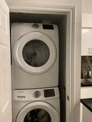 a washing machine and a washer in a kitchen at PlanURstay in Mississauga