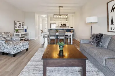 a living room with a couch and a table at 2 Bedroom Condo only steps to the Village! in Blue Mountains