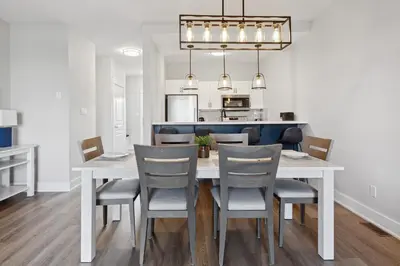 a kitchen and dining room with a white table and chairs at 2 Bedroom Condo only steps to the Village! in Blue Mountains