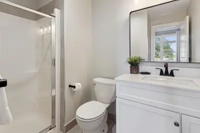 a bathroom with a toilet and a sink and a mirror at 2 Bedroom Condo only steps to the Village! in Blue Mountains