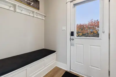 a room with a bench next to a door at 2 Bedroom Condo only steps to the Village! in Blue Mountains