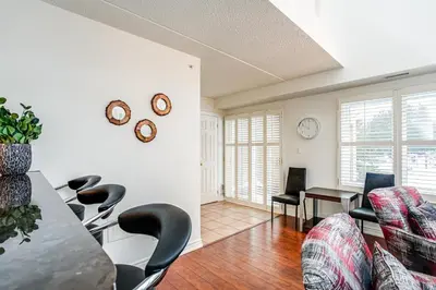 a living room with a table and chairs at 3 Bedroom Mountain Walk Condo, Steps to Village in Blue Mountains