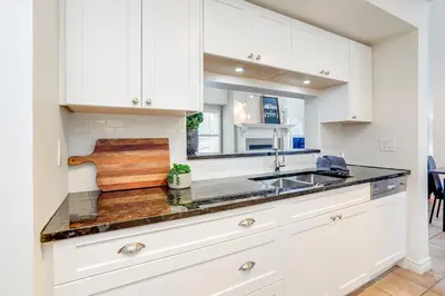 a kitchen with white cabinets and a sink at 3 Bedroom Mountain Walk Condo, Steps to Village in Blue Mountains