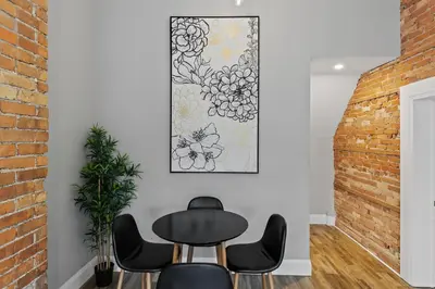a dining room with a black table and chairs at ENTIRE 1 BEDROOM APARTMENT ACROSS FROM GOOGLE - br5 in Kitchener