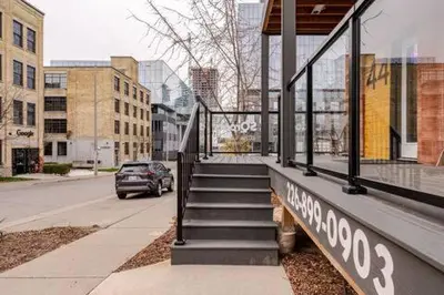 a building with a staircase on the side of a street at ENTIRE 1 BEDROOM APARTMENT ACROSS FROM GOOGLE - br5 in Kitchener