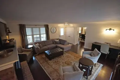 an aerial view of a living room with a couch and chairs at Arrowstone Farmhouse in Historic Old Town in Niagara on the Lake