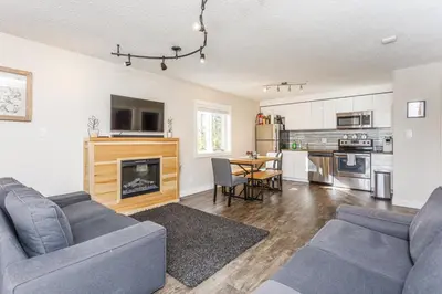 a living room with two couches and a kitchen at Cozy Collingwood Retreat 80204 in Collingwood