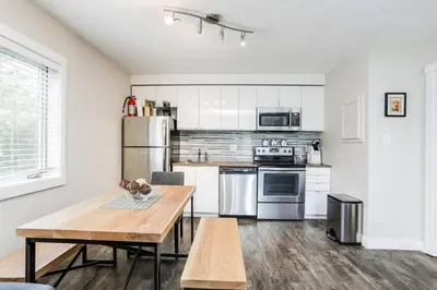 a kitchen with stainless steel appliances and a wooden table at Cozy Collingwood Retreat 80204 in Collingwood