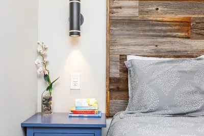 a bedroom with a bed with a blue nightstand next to a bed at Cozy Collingwood Retreat 80204 in Collingwood