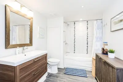 a bathroom with a sink and a toilet and a tub at Cozy Collingwood Retreat 80204 in Collingwood