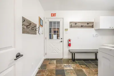 a kitchen with a white door and a bench at Luxurious Private House Pool and Hot Tub in Blue Mountains