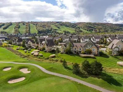 an aerial view of a golf course with houses at 2 Bedroom Rivergrass with a View in Blue Mountains