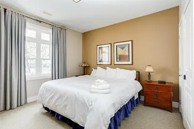 a bedroom with a large white bed and a window at 2 Bedroom Rivergrass with a View in Blue Mountains