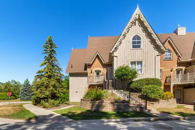 a house in a residential neighborhood with a stop sign at Blue Mountain 3 bedroom Dream Chalet 81590 in Collingwood