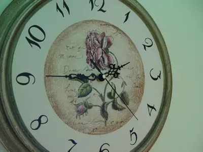 a clock with a flower on it on a wall at Our Valley View Bed & Breakfast in Hampton