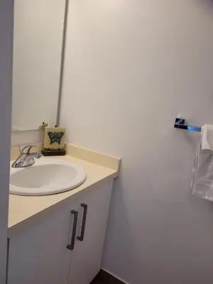 a bathroom with a sink and a white counter at Two BD CN Tower and Lake Ontario View in Toronto