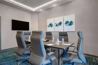 a conference room with a table and chairs and a tv at Hampton Inn & Suites By Hilton Waterloo St. Jacobs in Waterloo