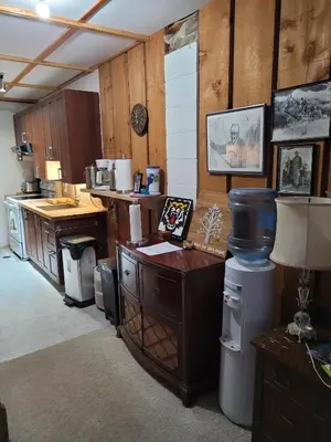 a kitchen with wooden cabinets and a counter top at Whispering Pines Suite at The Bowering Lodge in Blue Mountains