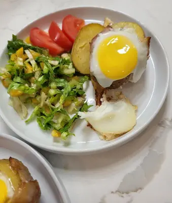 a plate of food with an egg and a salad at La Maison de Sophie in Niagara on the Lake