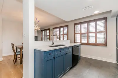 a kitchen with blue cabinets and a sink at Stunning Townhouse - 3 BDRM Blue Mountain Village Sauna! in Blue Mountains