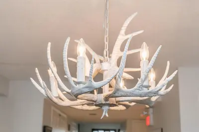 a chandelier with antlers hanging from a ceiling at Stunning Townhouse - 3 BDRM Blue Mountain Village Sauna! in Blue Mountains