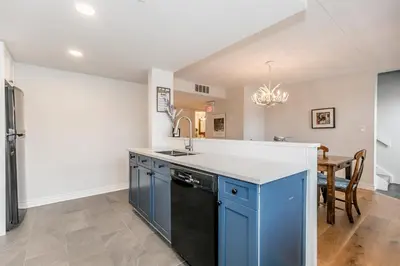 a kitchen with blue cabinets and a sink at Stunning Townhouse - 3 BDRM Blue Mountain Village Sauna! in Blue Mountains