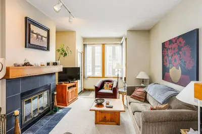 a living room with a couch and a fireplace at Ski In Out Mountainside Chalet 83001 in Blue Mountains