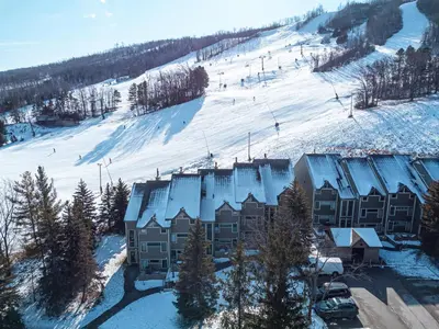 an aerial view of a ski lodge with snow covered roofs at Ski In Out Mountainside Chalet 83001 in Blue Mountains