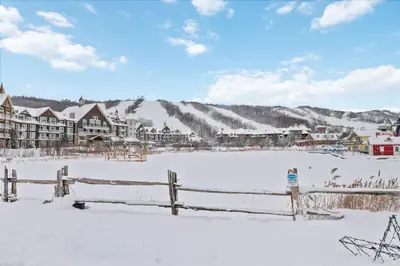 a town in the snow with a fence at Ski In Out Mountainside Chalet 83001 in Blue Mountains
