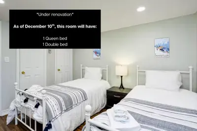 a bedroom with two beds and a sign that reads as of december utopia at Wintergreen Retreat with Private Sauna & Patio 82291 in Blue Mountains