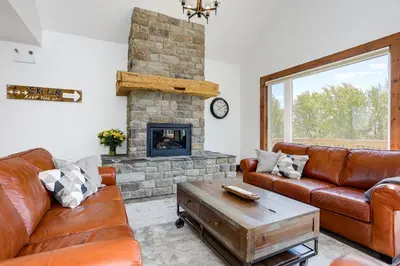a living room with a couch and a fireplace at Luxury Mountain Retreat with private hot tub 82958 in Blue Mountains