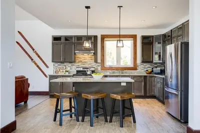 a kitchen with stainless steel appliances and wooden cabinets at Luxury Mountain Retreat with private hot tub 82958 in Blue Mountains