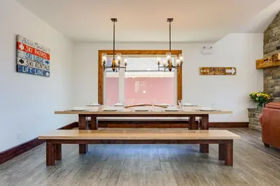 a dining room with a table and a window at Luxury Mountain Retreat with private hot tub 82958 in Blue Mountains