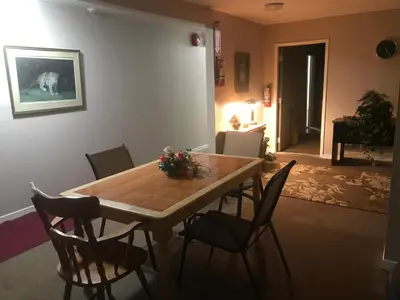 a dining room table and chairs in a room at Earthquest Lodge in Port Burwell