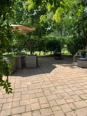 a patio with an umbrella and a picnic table at THE YORK HOUSE BOUTIQUE Stay in Fort Erie