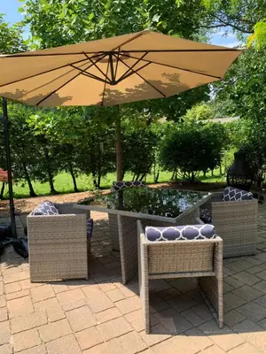 an umbrella over a table with chairs and a fountain at THE YORK HOUSE BOUTIQUE Stay in Fort Erie