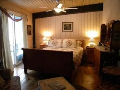 a bedroom with a bed and a ceiling fan at Stouffermill Bed & Breakfast in Algonquin Highlands