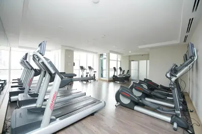 a gym with several tread machines in a room at PlanURstay - Amazing 2BR & 2BTH - Near Square One Mall in Mississauga