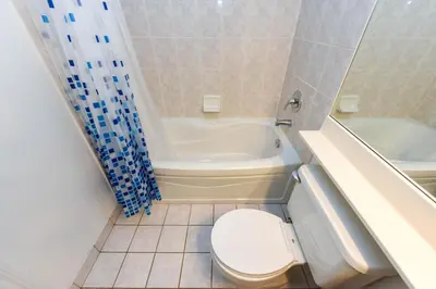 a bathroom with a toilet and a tub and a sink at PlanURstay - Amazing 2BR & 2BTH - Near Square One Mall in Mississauga