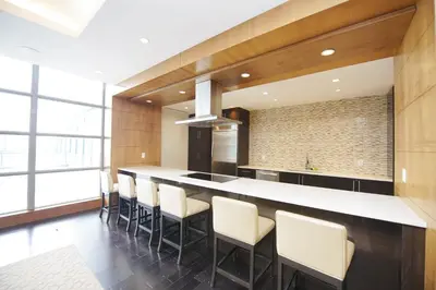 a kitchen with a large island with stools at PlanURstay - Amazing 2BR & 2BTH - Near Square One Mall in Mississauga