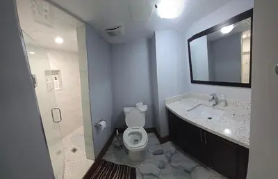 a bathroom with a toilet and a sink and a mirror at Prestige Accommodation in Ajax