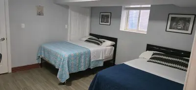 a bedroom with two beds and a window at Prestige Accommodation in Ajax