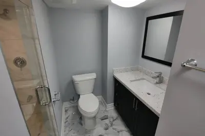 a bathroom with a toilet and a shower and a sink at Prestige Accommodation in Ajax