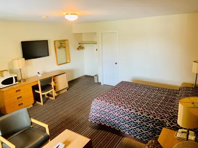 a hotel room with a bed and a desk at Toronto Lakeshore Hotel in Mississauga