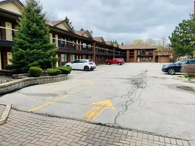 a parking lot in front of a large building at Toronto Lakeshore Hotel in Mississauga