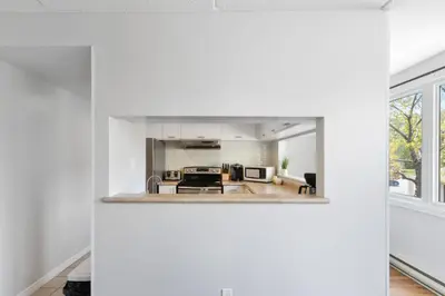 a kitchen with white walls and a large mirror at Mountain View Wintergreen Home 84140 in Blue Mountains