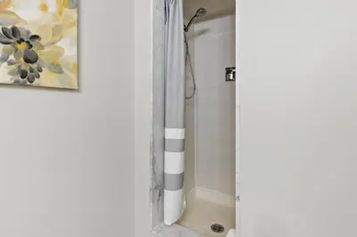 a bathroom with a shower with a shower curtain at Mountain View Wintergreen Home 84140 in Blue Mountains