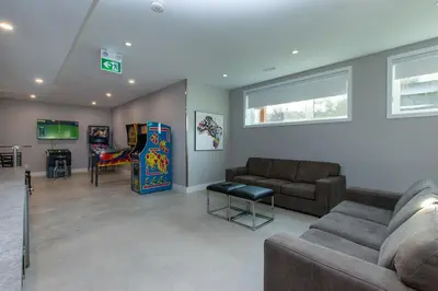 a living room with a couch and a video game at 107 Birchview Trail in Blue Mountains